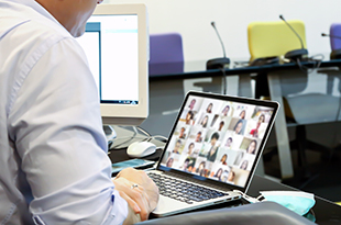 A man attends a meeting via Zoom.