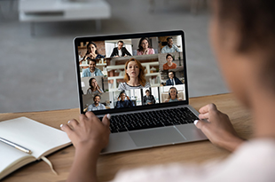 A laptop with a Zoom meeting on screen.