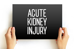 Hands hold a sign saying "acute kidney injury"