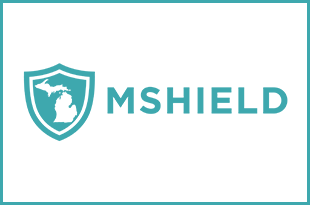 The MSHIELD logo is displayed. It's an aqua-colored logo on white background. The logo consists of a drawing of a map of Michigan in white on an aqua shield. "MSHIELD" is spelled out to the right of the shield image.