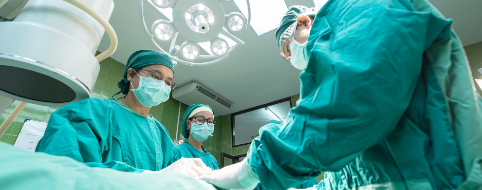 Surgeons work in an operating room.
