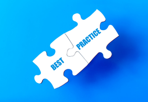 Two white puzzle pieces, one stating "best" and the other "practices" in blue, are connected on a medium blue background.