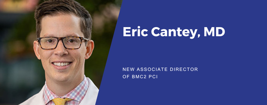 Eric Cantey, MD is the new associate director of BMC2 PCI. Eric has short brown hair. He is smiling and wearing glasses and a white lab coat over a blue and pink plaid collared shirt with a yellow tie.